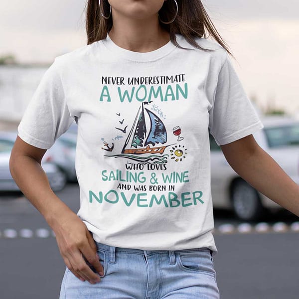 never underestimate a woman who loves sailing and wine shirt november